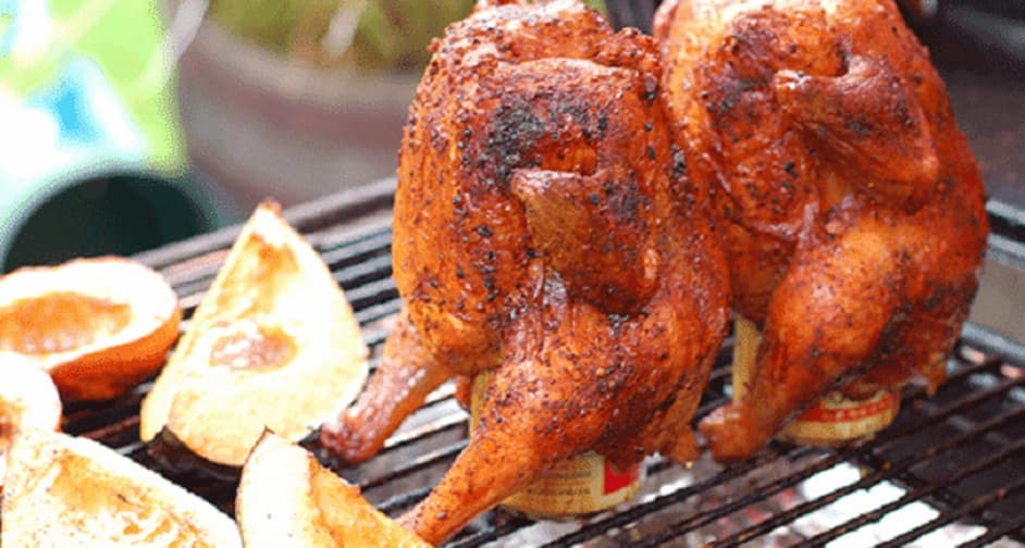 BBQ beer can chicken grilled upright over an open flame, seasoned with spice rub and cooked until crispy on the outside and juicy inside
