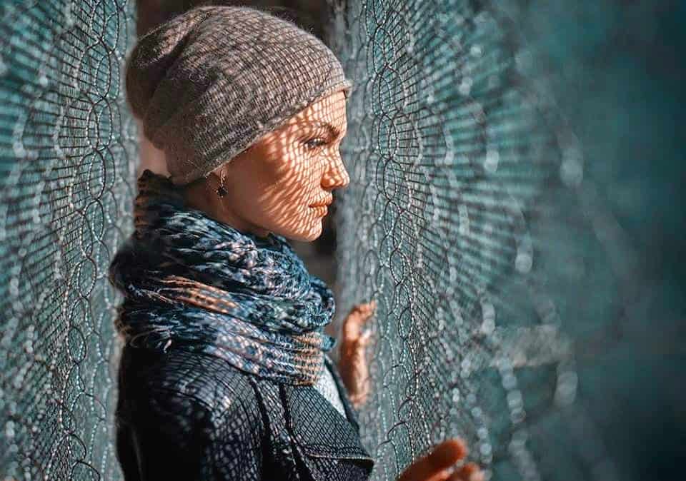 Woman in contemplation of "Why Me?", behind a fence, symbolizing self-reflection, boundaries, and emotional healing