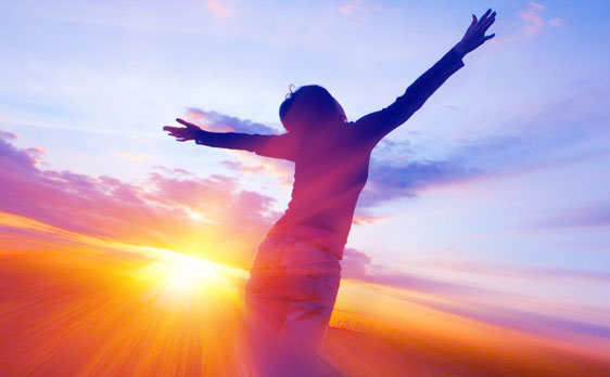 Woman embracing sunlight and spiritual clarity after receiving a high quality psychic reading