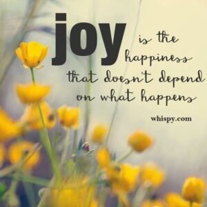 Inspirational quote about joy and happiness with yellow flowers in soft focus