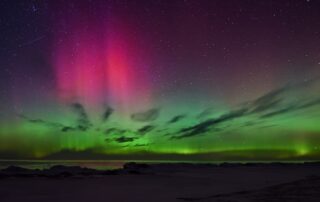 Northern lights in a dark sky, symbolizing uncertainty, transformation, and leaving solid ground and familiar surroundings