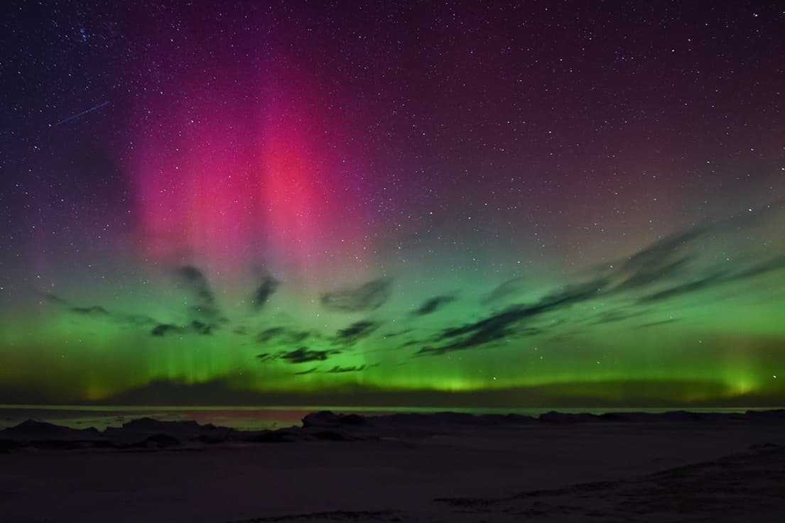 Northern lights in a dark sky, symbolizing uncertainty, transformation, and leaving solid ground and familiar surroundings