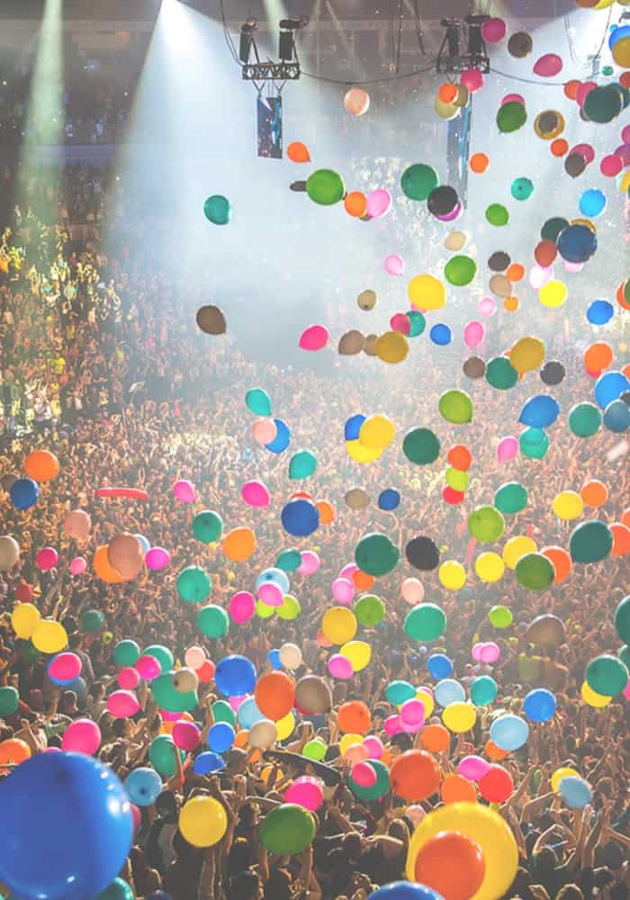 Colorful balloons rising above a joyful crowd, symbolizing release, renewal, and the freedom of spirit